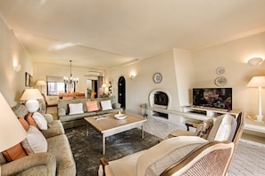 A living room with a sofa set, a coffee table, a fireplace, and a television. - Villa "Mng Elliott 72" with Private Pool & Wi-Fi (Vale do Lobo)