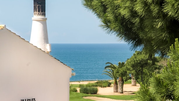 A coastal building with a lighthouse, a tiled roof, and a view of the sea. - Villa 'Mng Elliott37' with Private Pool, Wi-Fi and Air Conditioning (Vale do Lobo)