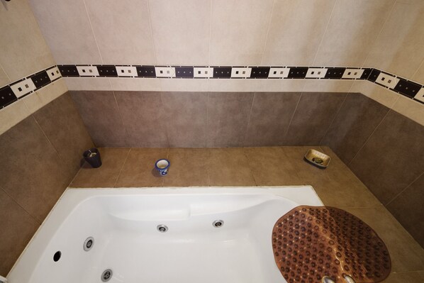 A bathroom with a bathtub, a shower, and a toilet.