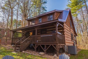 A wooden cabin with a deck, built into a forested area. - Hidden Hideaway 2 Bedroom Cabin by RedAwning (Cosby)