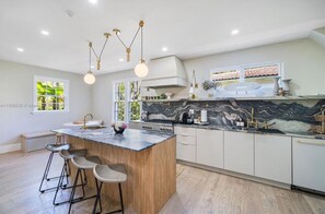 Enjoy cooking in this well-lit kitchen with a central island and sink.