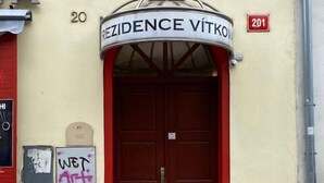 A building entrance with a sign reading "REZIDENCE VITKOY" and the number "20" above the door.