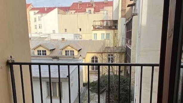 A balcony with a view of neighboring buildings.