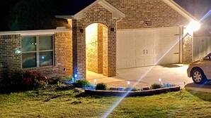 A brick house with a garage, a driveway, and a lawn. - Charming 3BR Retreat Near Tyler Airport & Downtown (Tyler)