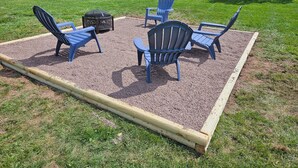 A deck with four Adirondack chairs and a fire pit. - Comfortable, spacious home near Knoebels. (Catawissa)