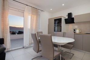Enjoy meals in the dining area with a round table and four chairs, and prepare snacks in the kitchenette with a microwave, oven, and coffee maker.