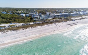 An aerial view of a coastal resort with beachfront properties, a sandy beach, and clear turquoise waters. - Single Level WaterColor Home - Steps to Seaside - 3 Bikes (Santa Rosa Beach)