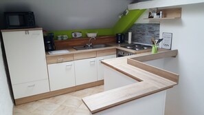 Fridge, microwave, stovetop, coffee/tea maker