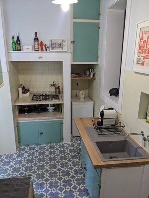 Fridge, microwave, coffee/tea maker, cookware/dishes/utensils