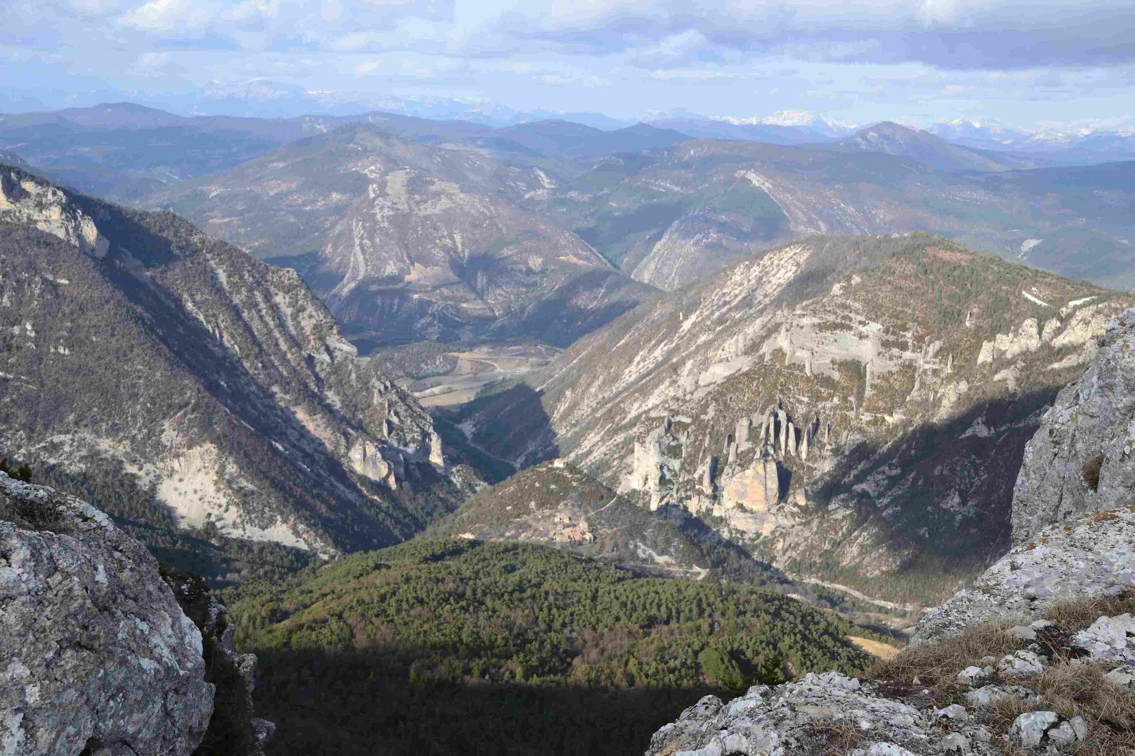 A mountainous landscape with rocky terrain and sparse vegetation.