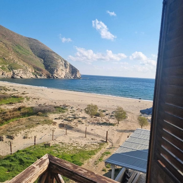 A beach with a view of the ocean and a mountainous landscape. - Despoina Rooms Potami (Karystos)