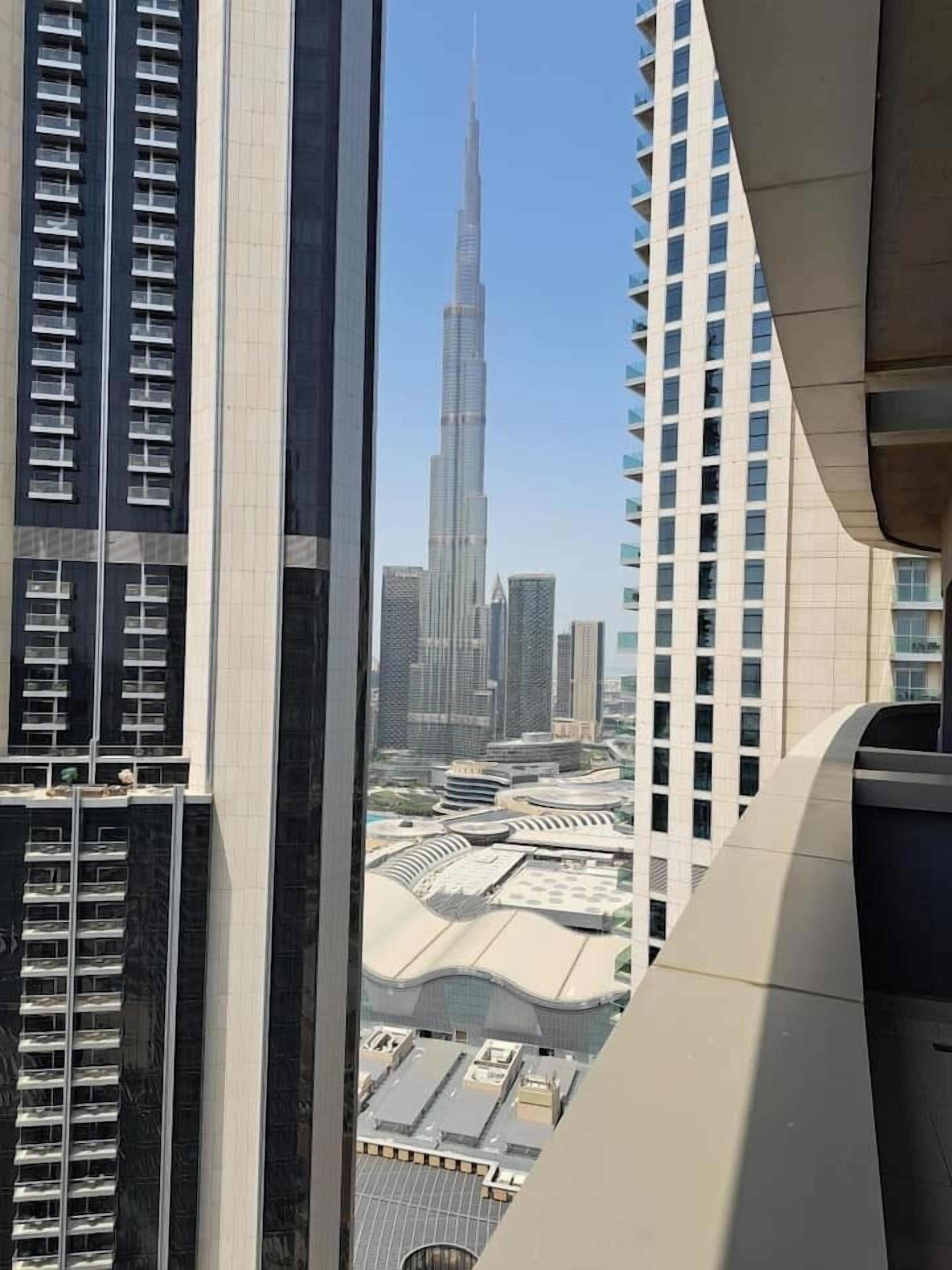 A high-rise building with a view of the Burj Khalifa in the background.
