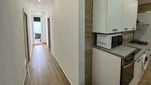 Une cuisine moderne avec des meubles blancs, un four à micro-ondes et une cuisinière.