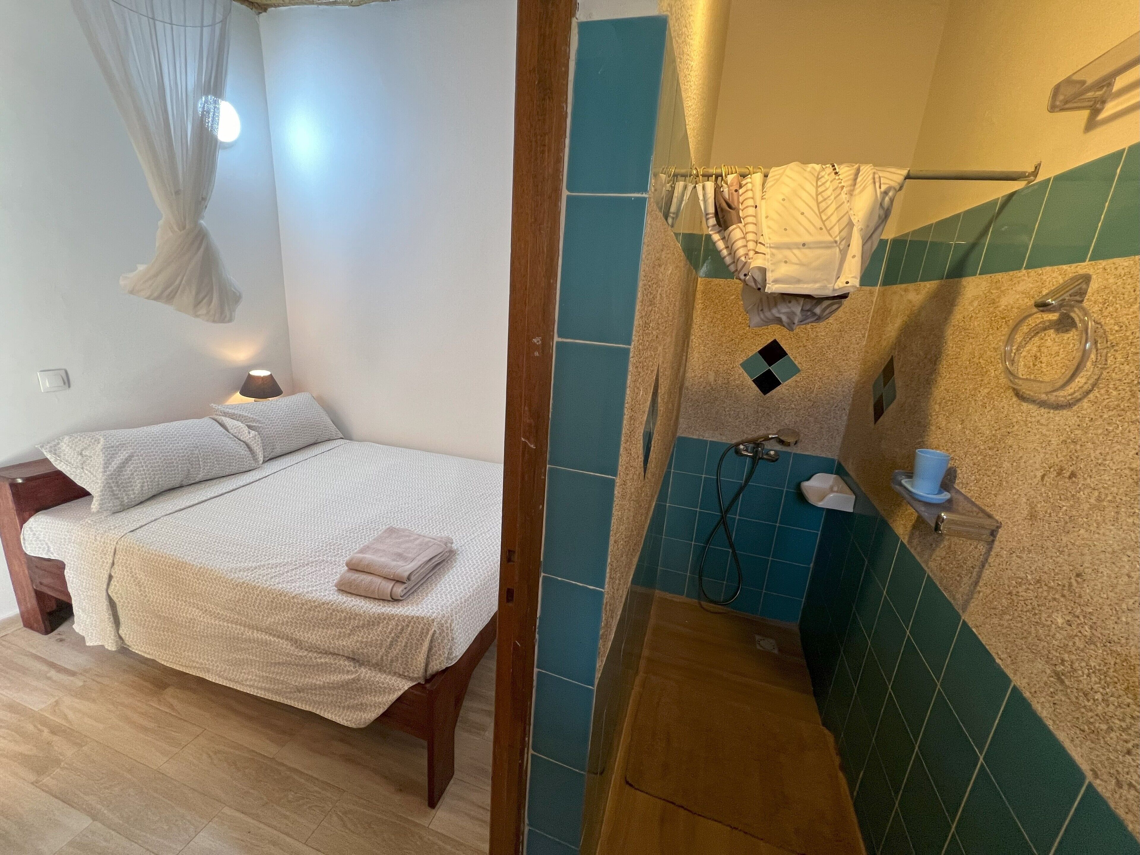 Une chambre à coucher avec un lit, des lampes de chevet et un baldaquin suspendu.