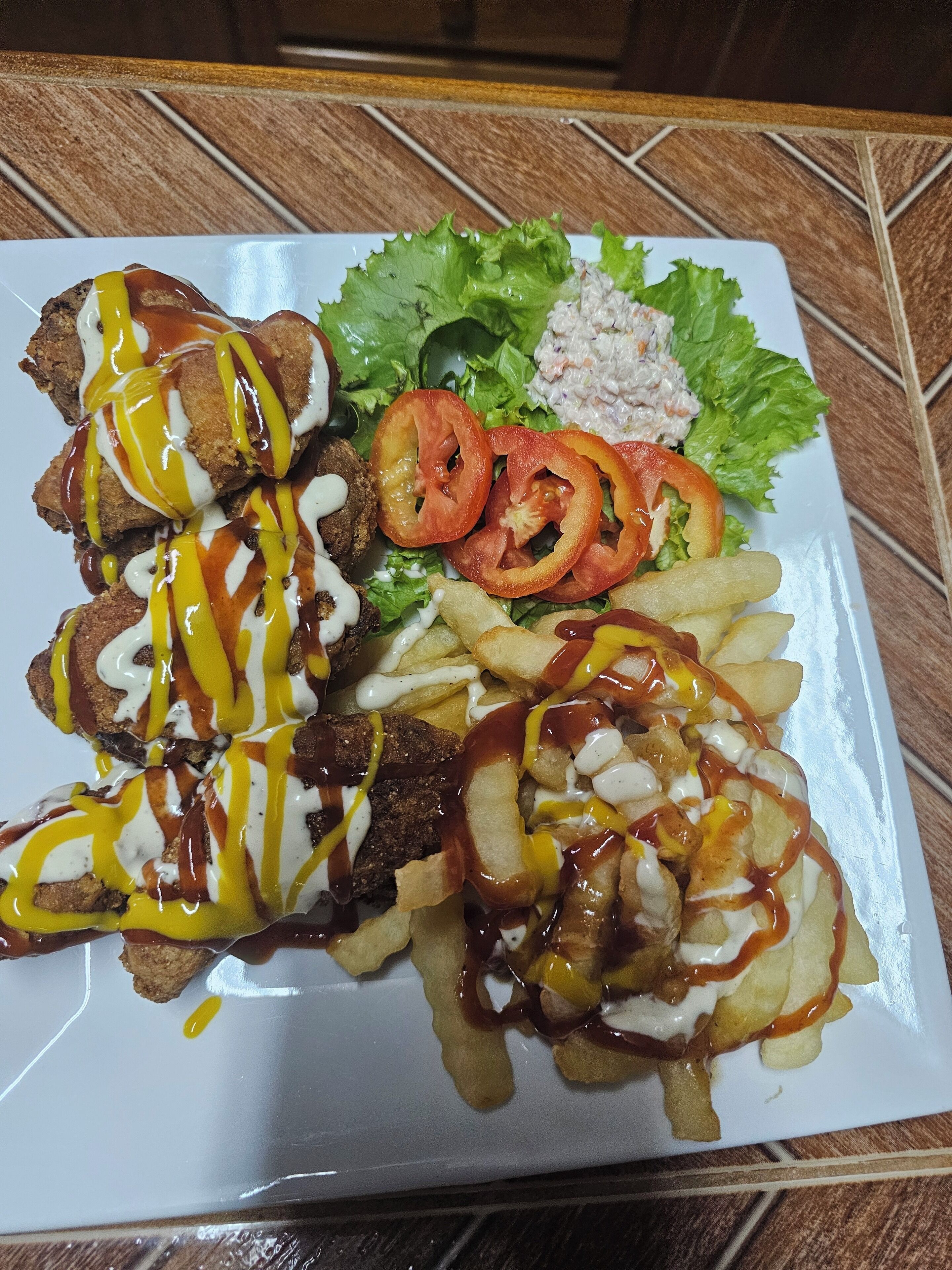 A plate of food with fries, a salad, and meat.