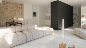 A modern living room with a sofa, a dining table, and a black partition. - TWO VAULTS, Rethymno old town (Rethymno)