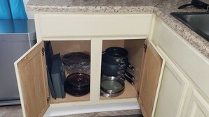 A kitchen with a granite countertop, a built-in oven, and a sink.