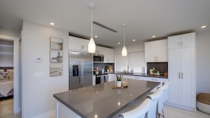 A modern kitchen with a central island, stainless steel appliances, and pendant lighting. - New Listing Sea Side Paradise.  Best of Key Largo! (Key Largo)