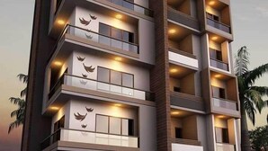 A multi-story building with balconies, large windows, and a modern architectural design. - Limited Edition (Addis Ababa)