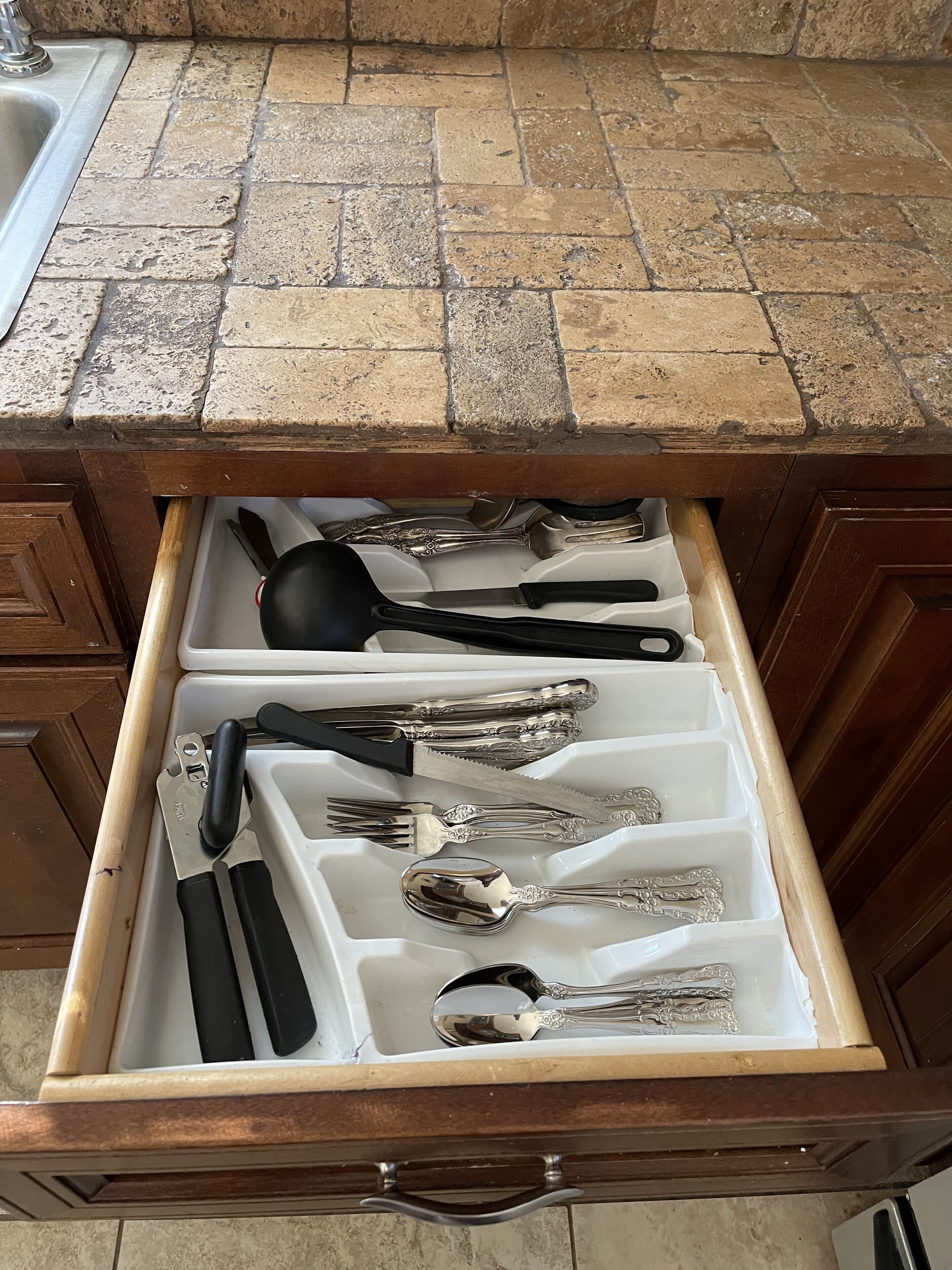 A kitchen drawer with utensils.