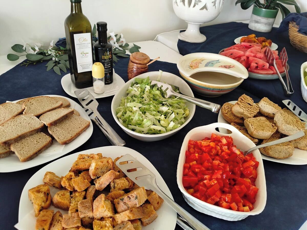 A table with various food items, including bread, salad, and diced vegetables.