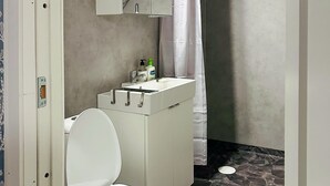 A bathroom with a white toilet, a sink with a mirror above it, and a shower curtain. - 1 bedroom awesome home in Gislaved (Gislaved)