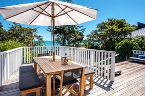 Outdoor dining - Newly renovated waterfront home, with large flat lawn leading to the beach. (Waiheke Island)
