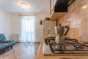 Fridge, microwave, coffee/tea maker, cookware/dishes/utensils