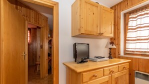 A wooden cabinet with drawers and a television on top. - Casa Coli (Mazzin)
