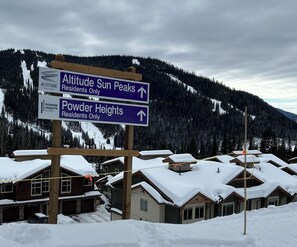 A signpost with directions to Altitude Sun Peaks and Powder Heights, both marked as residents only.
