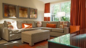 A modern living room with a sectional sofa, a coffee table, and two floor lamps. - Vacation Village at Parkway, Kissimmee, FL (Kissimmee)