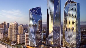 Trois gratte-ciel modernes aux lignes géométriques, qui s’élèvent au milieu d’un paysage urbain.