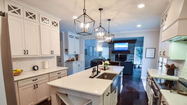 A modern kitchen with white cabinetry, a central island, and pendant lighting. - Private place to hide away. Endless fun w/pool & game room for multiple families (Fort Worth)