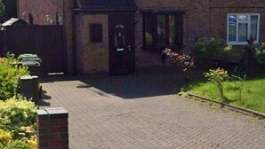 A two-story brick house with a tiled roof, a front porch, and a small garden area. - 1 Bed House - Parking & Wifi (Birmingham)