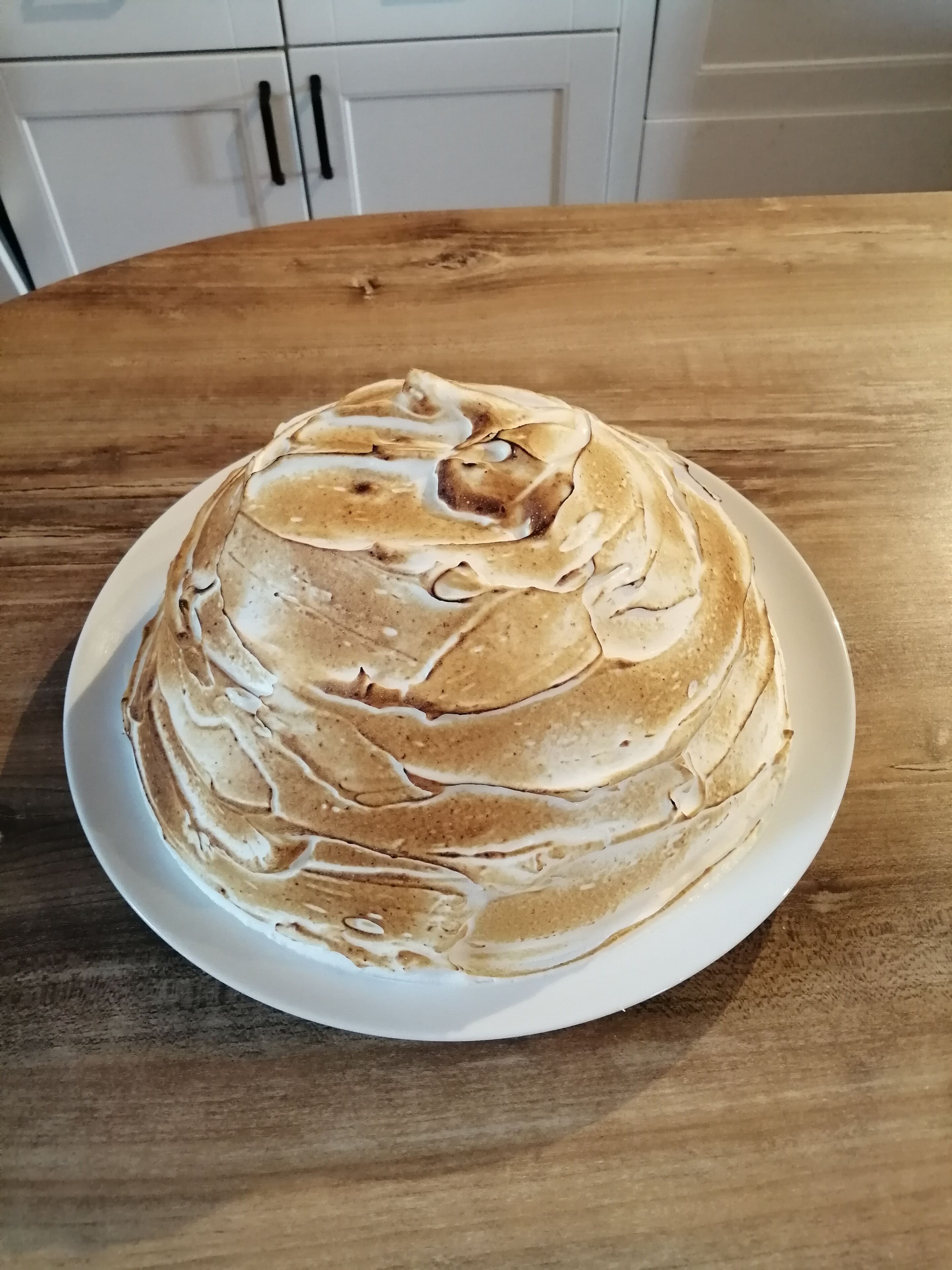 A round table with a white plate on top.