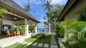 A resort with a pool, outdoor seating, and lush greenery. - Siri Mendira Beach Villas (Manggis)