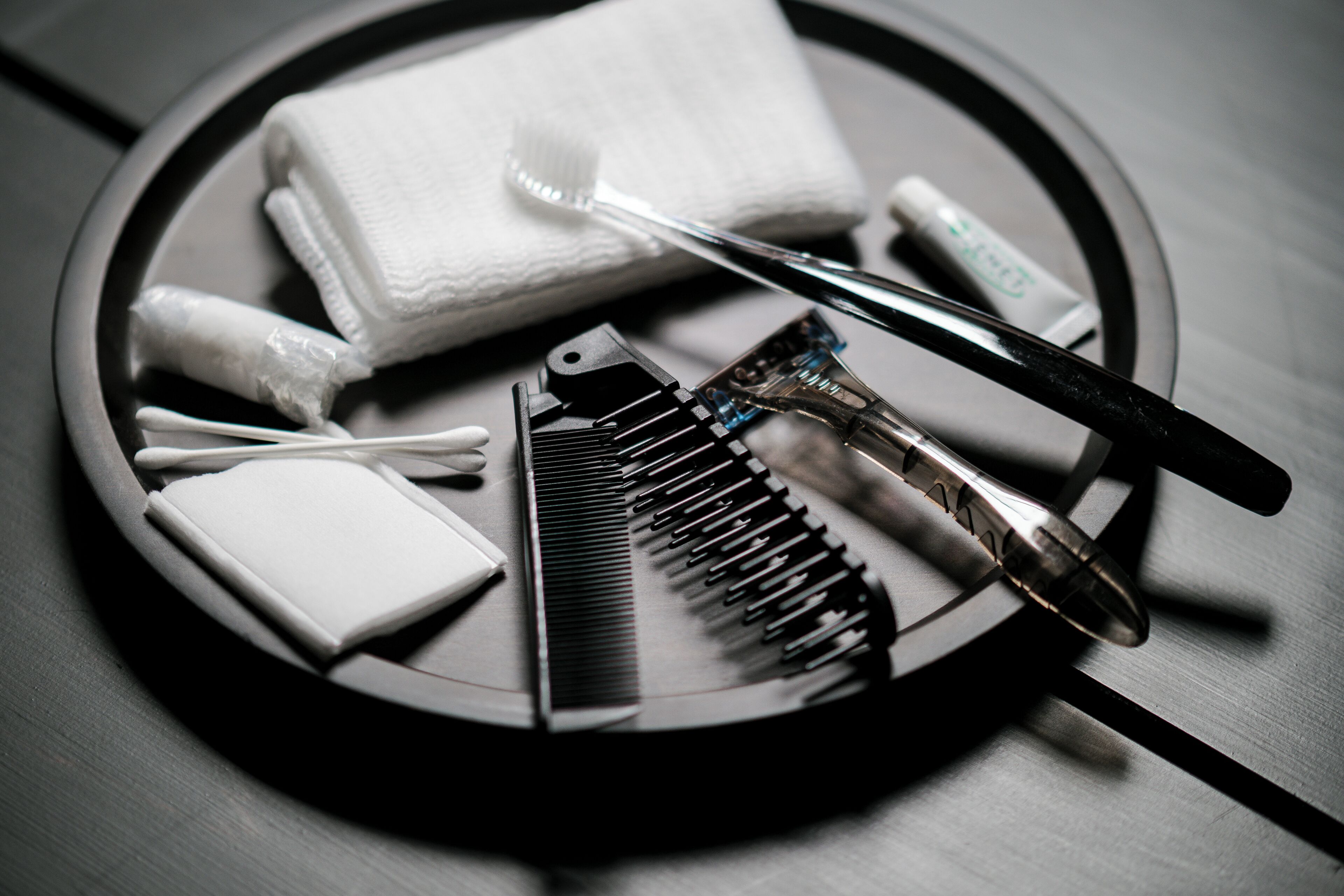A tray with a tissue, a toothbrush, a razor, and a comb.
