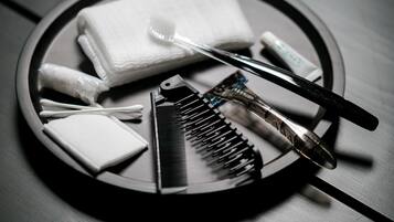 A tray with a tissue, a toothbrush, a razor, and a comb.