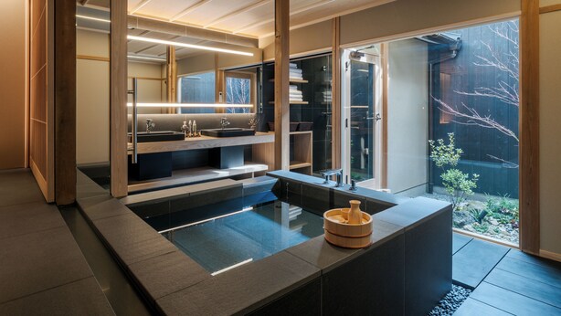 A modern bathroom with a large sink, a bathtub, and a shower area. There is a window providing a view of the outside. - ANJIN Gosho Ebisugawa (Kyoto)