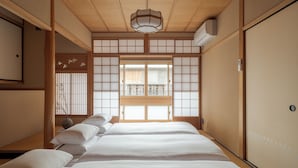 A traditional Japanese-style room with tatami flooring, a shoji screen door, and a wooden ceiling. - ANJIN Gosho Ebisugawa (Kyoto)