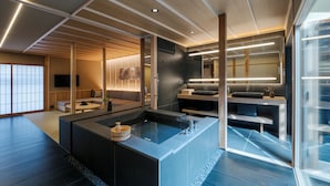 A modern interior with a central island, a kitchen area, and a seating space. - ANJIN Gosho Ebisugawa (Kyoto)