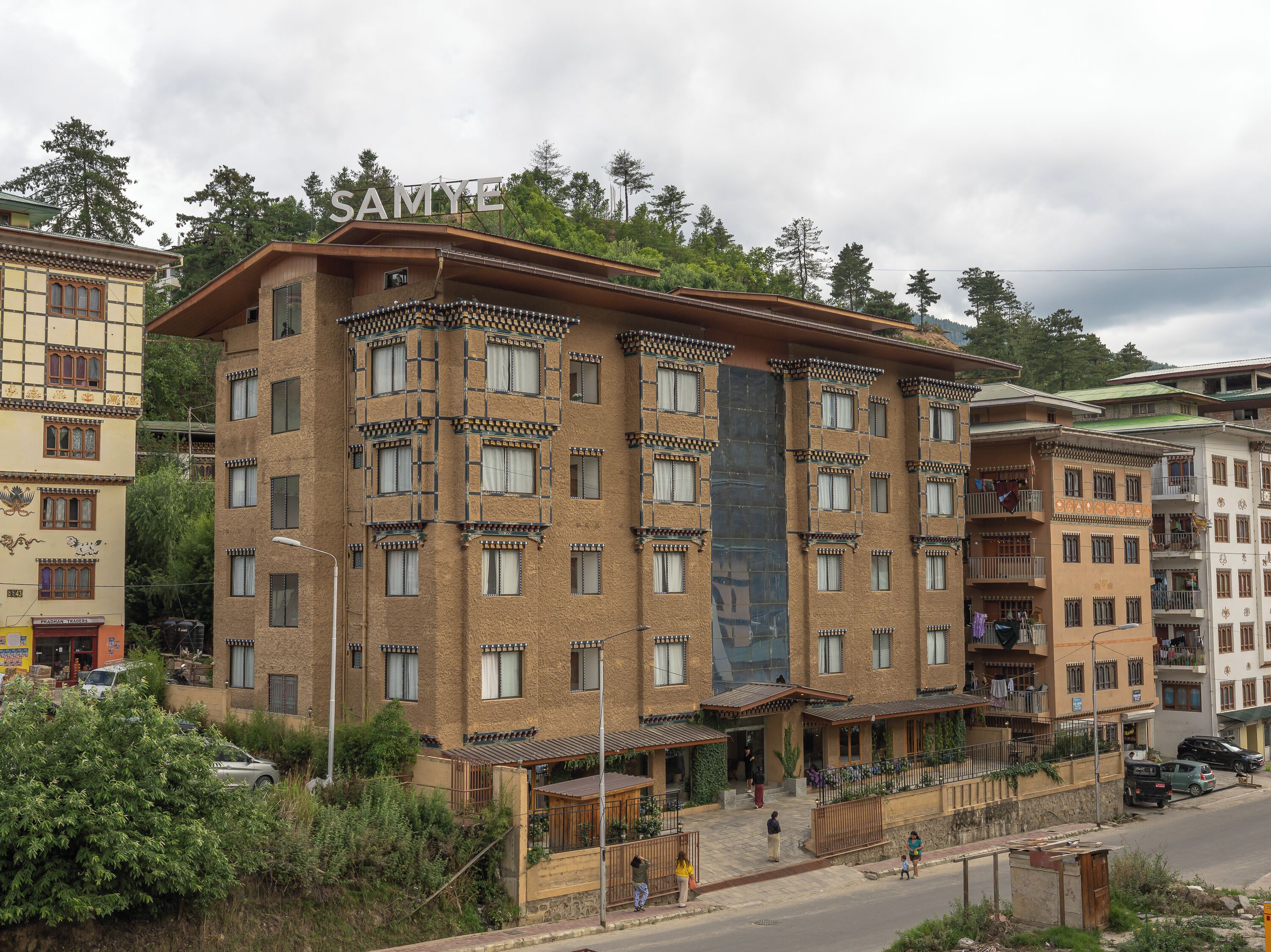 A multi-story building with a traditional architectural style, featuring a prominent entrance with a covered porch and multiple balconies.