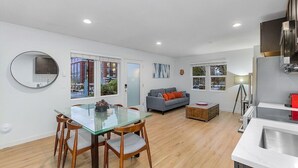 A modern apartment with a dining area, kitchen, and living space. - The Sweetest Hideaway - 81 Walkscore! (Seattle)