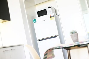 A white refrigerator with an energy rating sticker, a Hisense brand label, and a digital display.