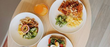 A breakfast tray with toast, fruit, and a cup of coffee.