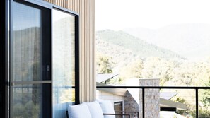 A balcony with a view of a mountainous landscape.