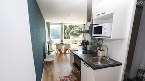 A modern kitchen with a microwave, sink, and wooden flooring. - St Cyprien, a gem on the port, everything within easy reach (Saint-Cyprien)
