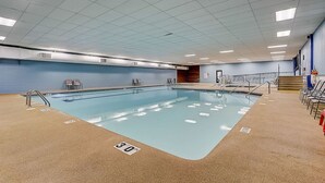An indoor swimming pool with a 30 ft depth marking, surrounded by a blue wall, with a staircase leading to a door on the right. - Peyton's Place at Tamarack - Great Location! (Wisconsin Dells)
