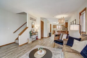A spacious living room with a staircase, a dining area, and a kitchen. - Peyton's Place at Tamarack - Great Location! (Wisconsin Dells)