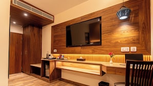 A modern bathroom with wooden paneling, a large mirror, and a built-in sink.